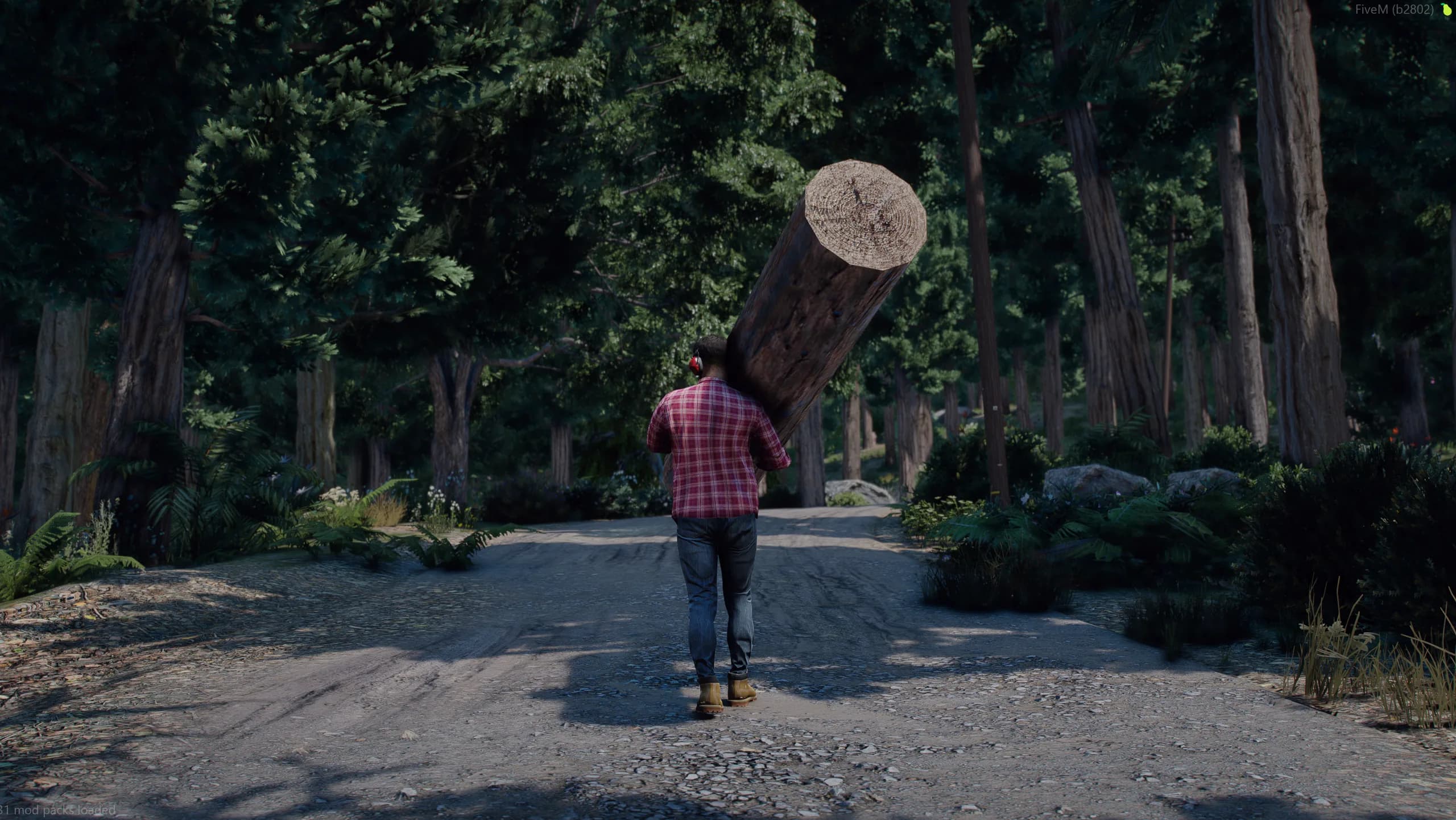 Lumberjack carrying a log down a forest road
